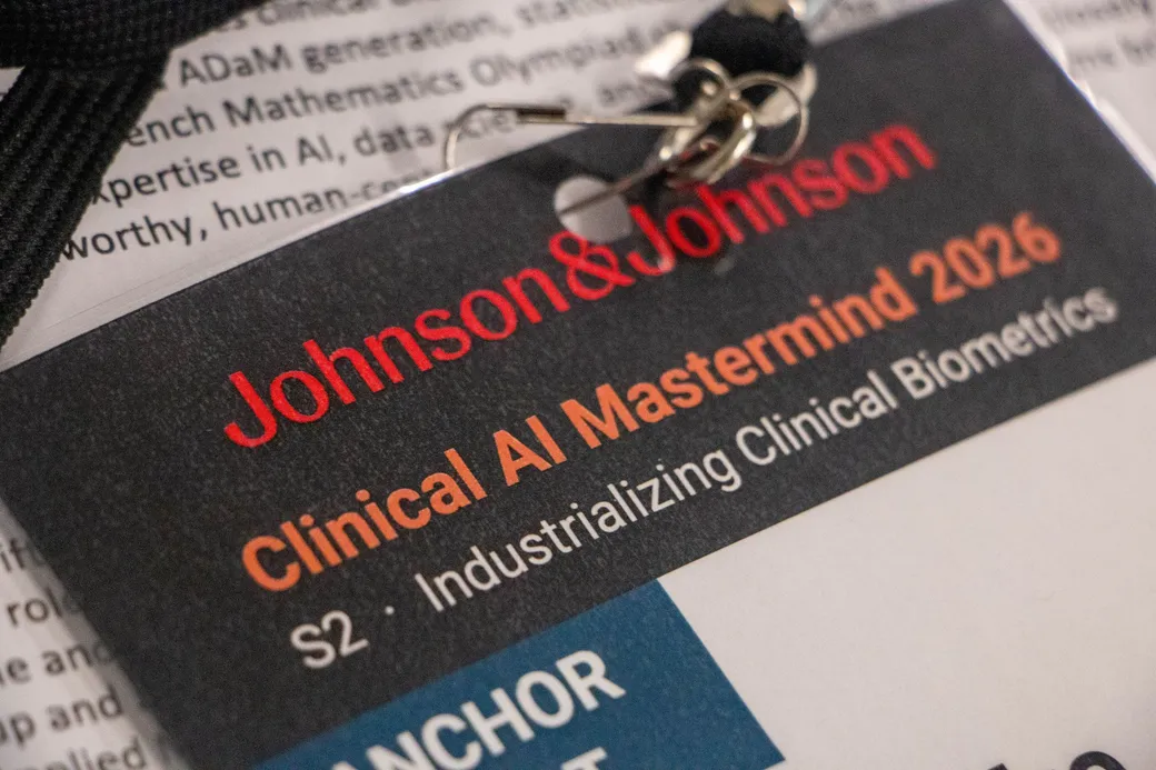 A Session 2 name badge resting on the printed program.