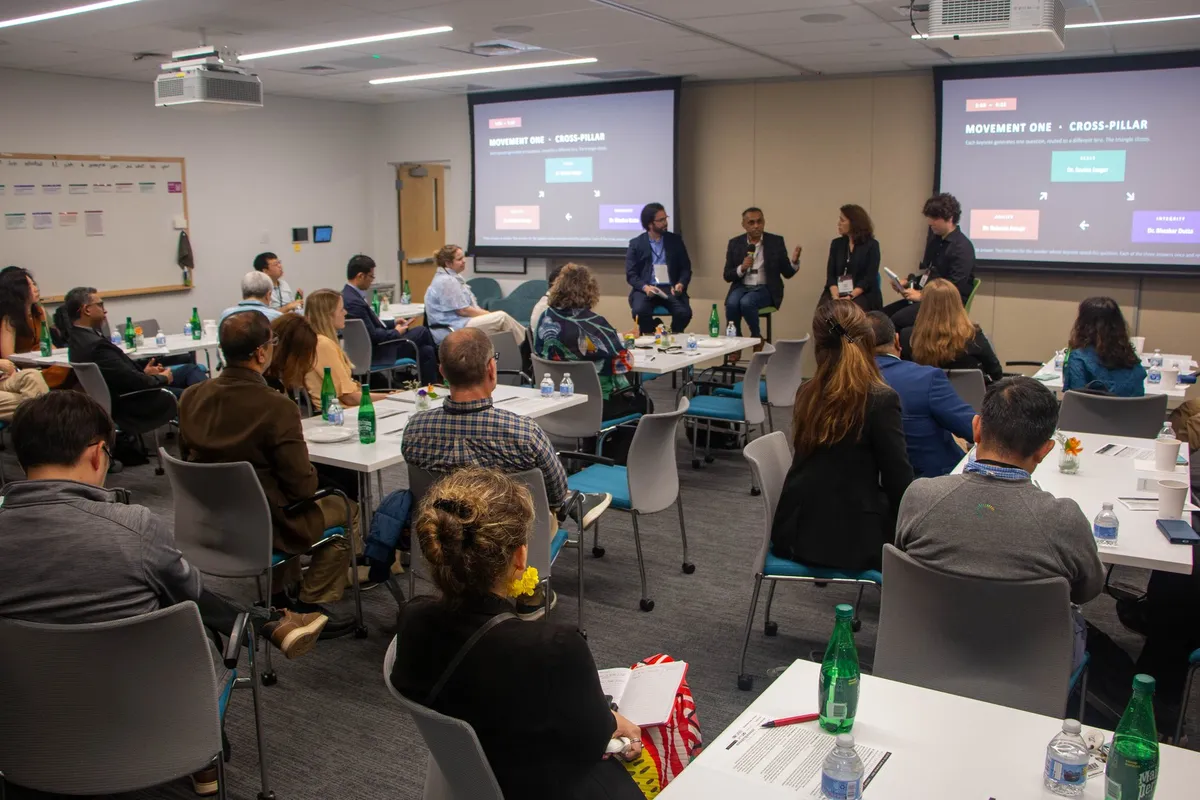 The room during the cross-pillar panel at Clinical AI Mastermind Session 2, with the wall of answer cards visible at left