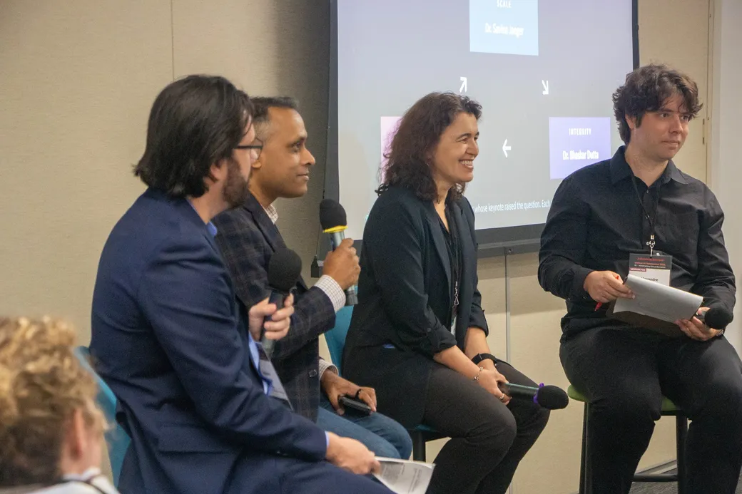 The three speakers and moderator during the cross-pillar block.